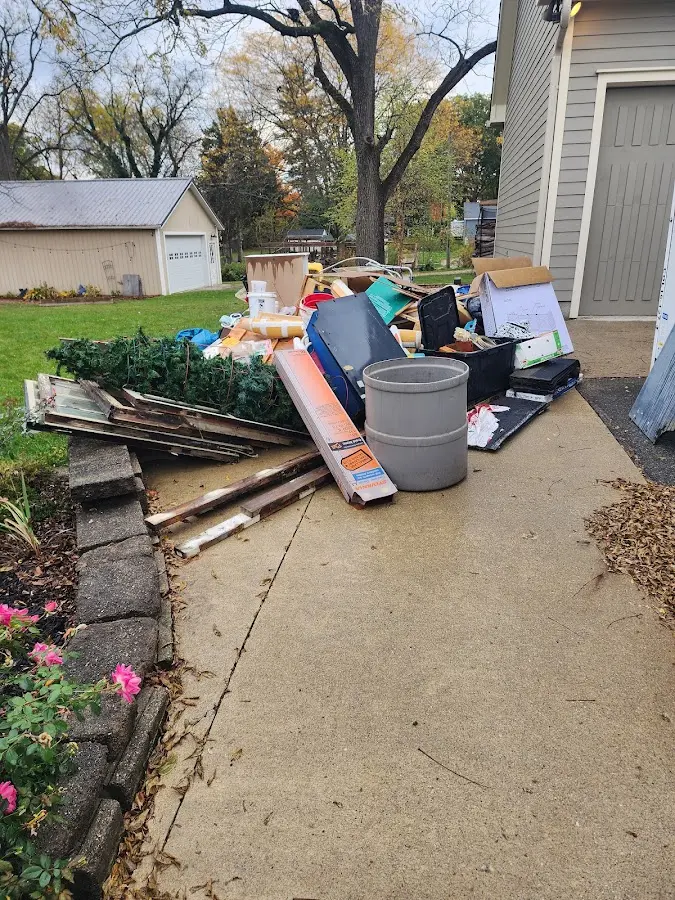 Dumpster being loaded with debris for 3 Yard Dumpster Rental in Gilford